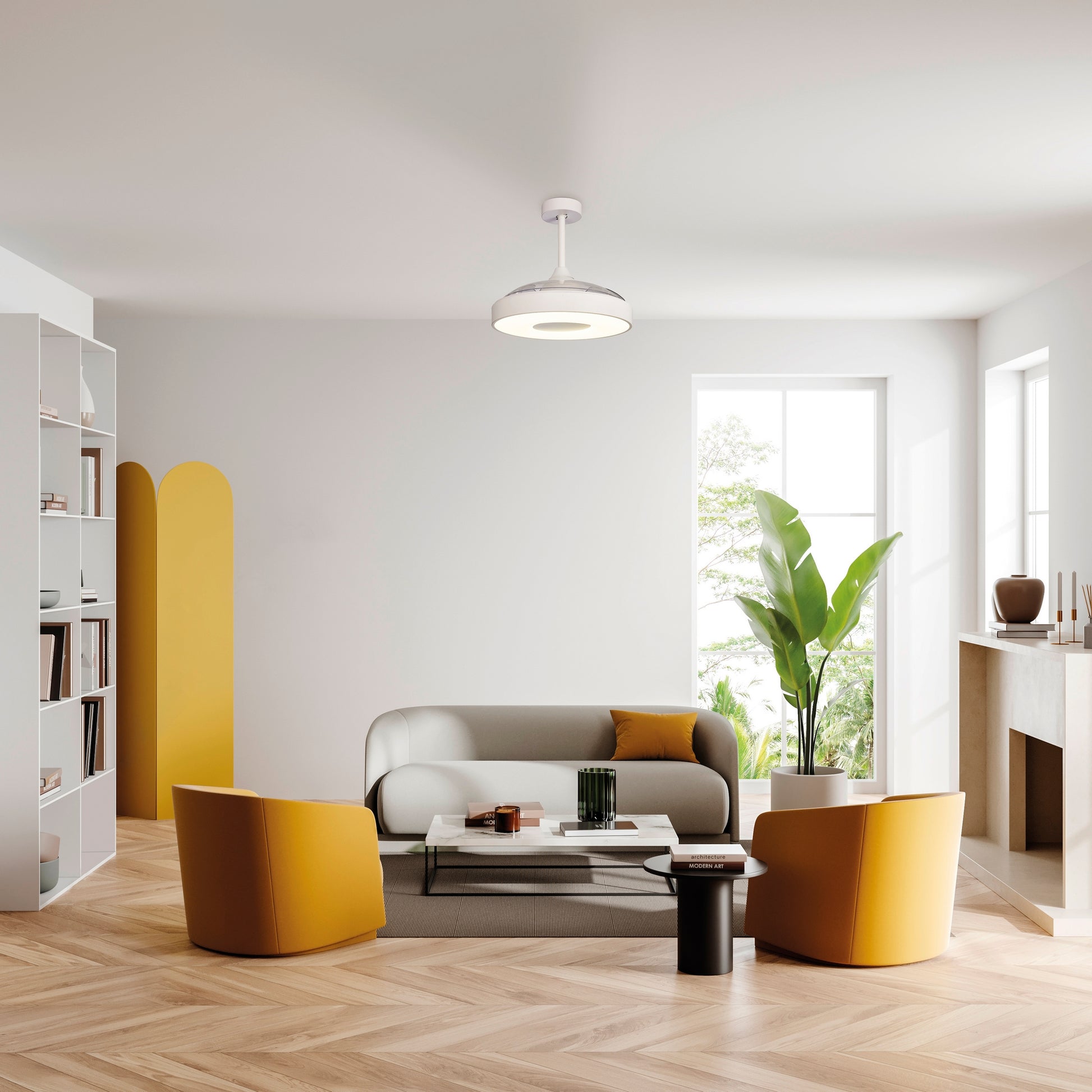 A modern, minimalist living room with a white ceiling and walls features a gray sofa, two yellow armchairs, a glass coffee table, and a large potted plant by the window. The built-in shelves on the left complement the fireplace on the right. For added convenience, the space is illuminated by Ceiling Fans UK's Coin White Ceiling Fan with light—a 60W LED dimmable ceiling light with a built-in 30W DC reversible fan that can be controlled via remote or APP and comes with a 5-year warranty.