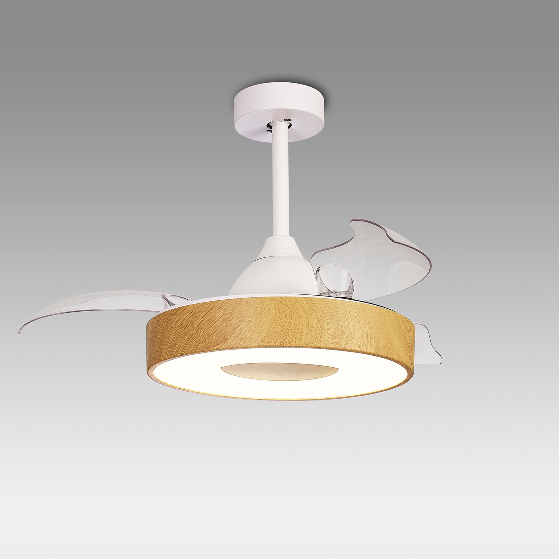 The Coin Mini White/Wood Ceiling Fan with Light by Ceiling Fans UK features a contemporary design with a cylindrical wooden frame and an open circular base for illumination. It includes abstract, translucent wing-like protrusions on the sides and is suspended from a white ceiling mount. This 45W LED dimmable ceiling light also comes with a built-in 25W DC reversible fan, remote and app controls, and is backed by a 5-year warranty.