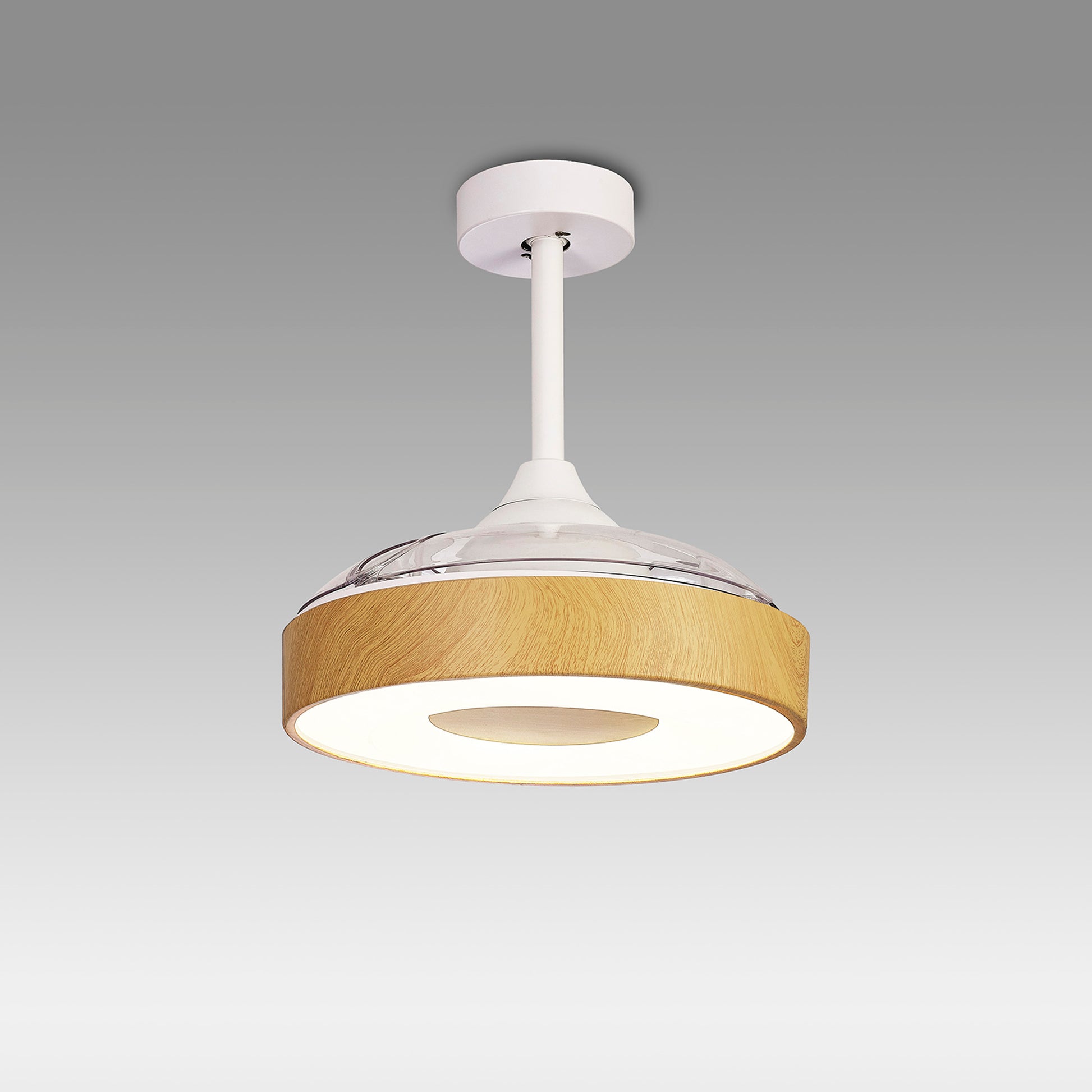 Introducing the Coin Mini White/Wood Ceiling Fan with Light from Ceiling Fans UK. This sleek, minimalist ceiling fixture features a white base accented by wood surrounding an LED dimmable light, offering both style and function. The round design is suspended from a white rod against a plain gray background and includes a built-in 25W DC reversible fan. Control it easily via remote or app, backed by a 5-year warranty for your peace of mind.