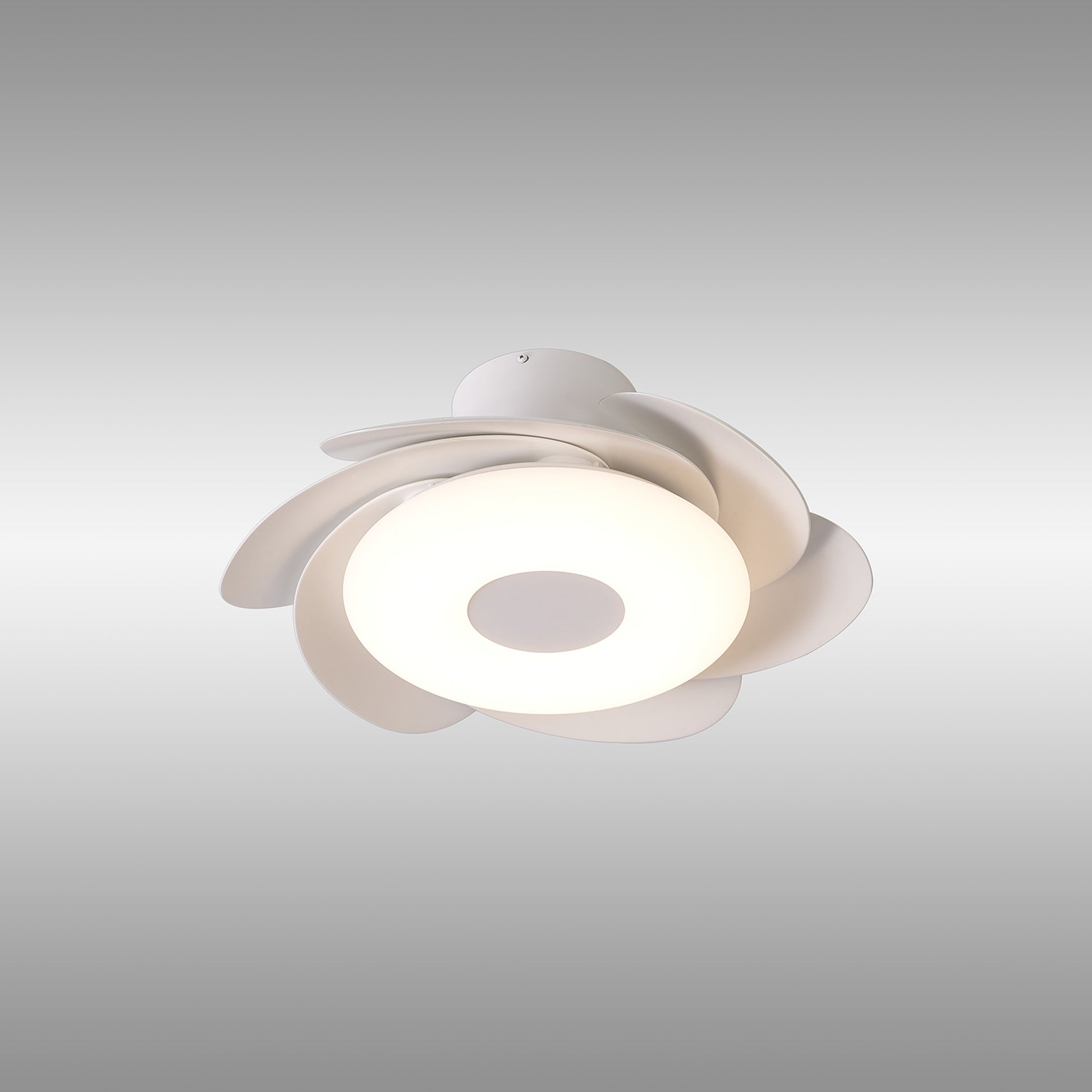 The Flower White Ceiling Fan with Light by Ceiling Fans UK features a modern design with a central circular 24W dimmable LED light source and petal-like white shades arranged in a floral pattern. It also includes a 25W built-in reversible DC fan and comes with remote control. The background is a plain gradient from light grey at the top to white at the bottom.