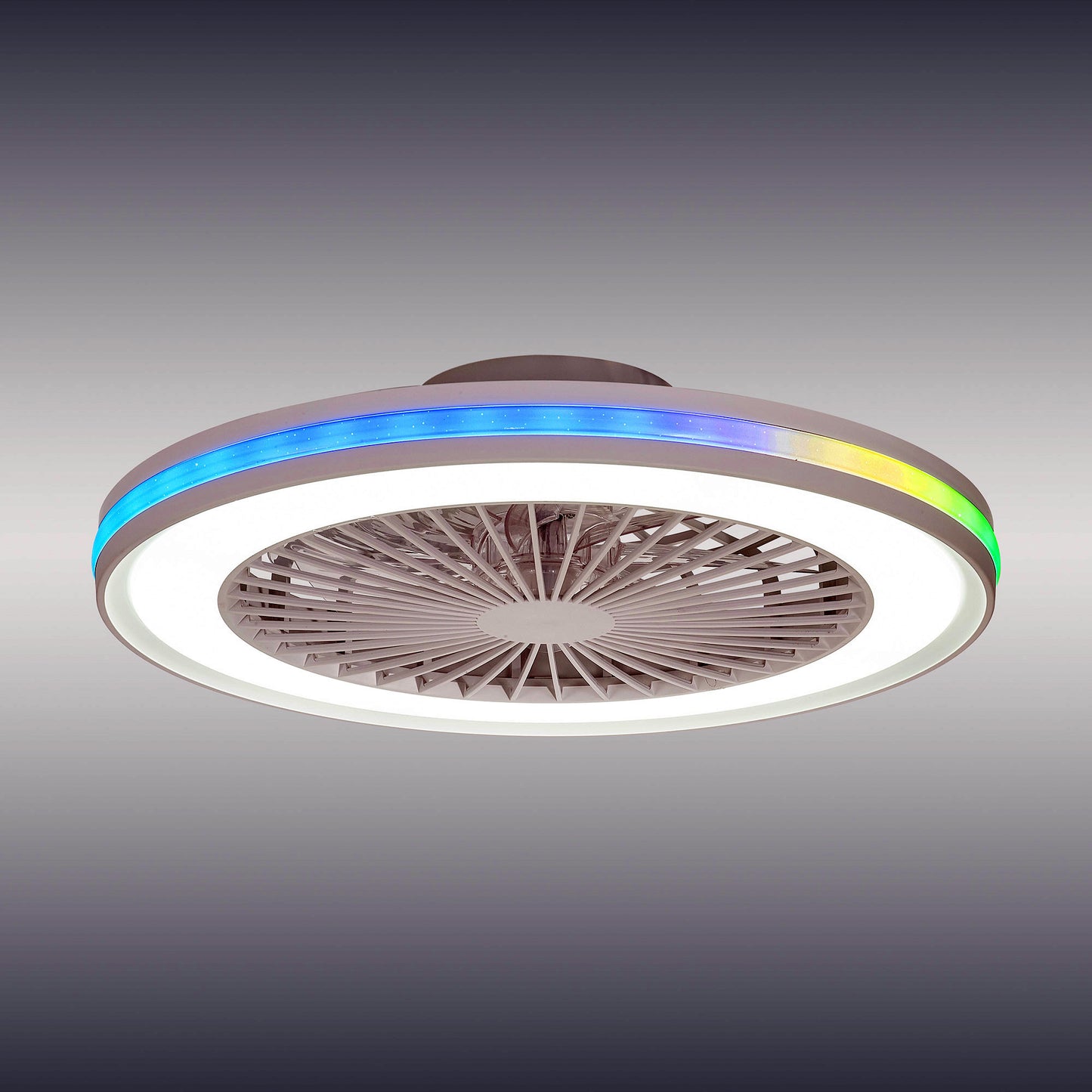 Introducing the Gamer Large White RGB/CCT Ceiling Fan by Ceiling Fans UK. This 53cm ceiling fan features a 60W dimmable LED light with an outer edge that displays a stunning gradient of colors including blue, green, and yellow. The 26W DC reversible fan is enclosed in a circular grille for added safety and style. Effortless control is at your fingertips with the included remote control. The background highlights its modern design with a gradient gray finish.