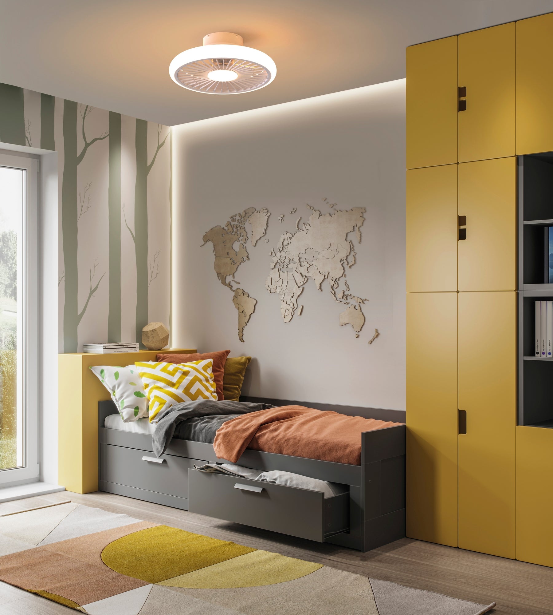 A modern bedroom featuring a compact bed with yellow and orange bedding, drawers underneath, yellow cabinets, and a wall adorned with a wooden world map and tree-patterned wallpaper. Sunlight streams in through a nearby window, illuminating the geometric rug on the floor and the Turbo White Ceiling Fan with Light by Ceiling Fans UK above. This 51.2cm unit offers a 55W LED dimmable ceiling light along with a built-in 30W DC reversible fan and comes with a 5-year warranty.